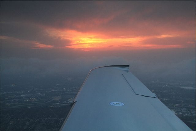 View of a plane wing out a window.