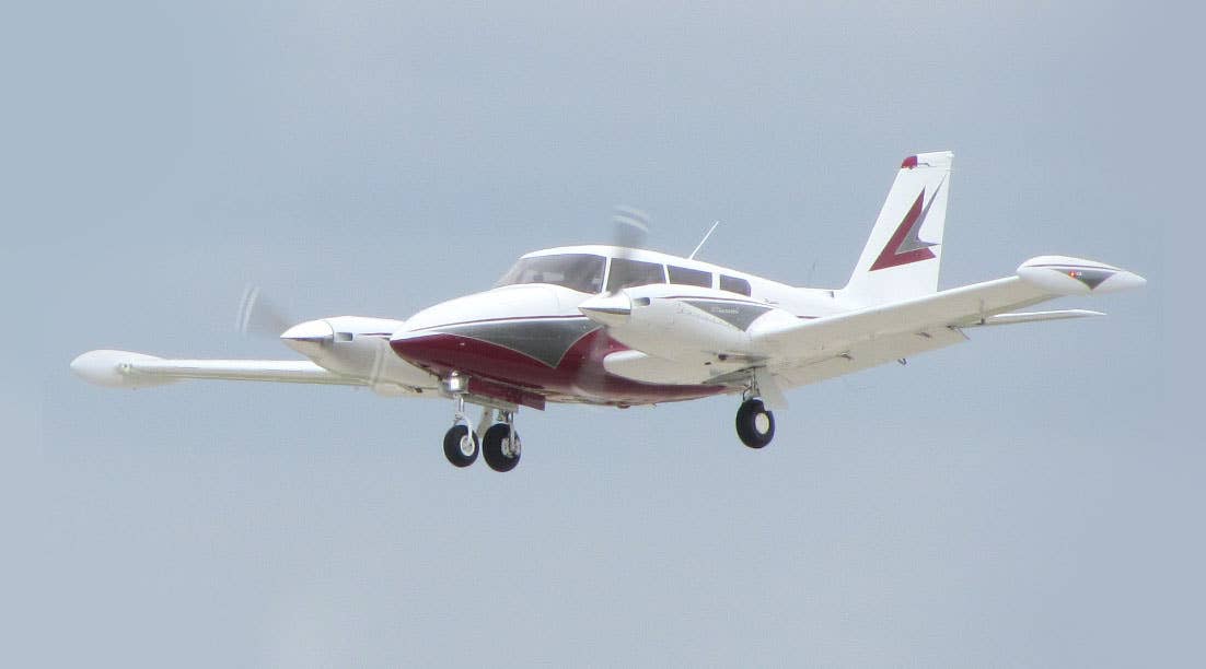 Piper Twin Comanche with aux fuel tanks.