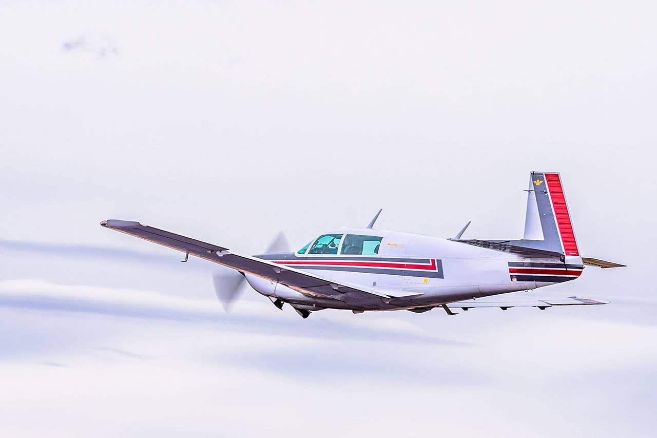 A Mooney flying in the clouds - How Threats Can Keep Pilots Safe - Plane & Pilot